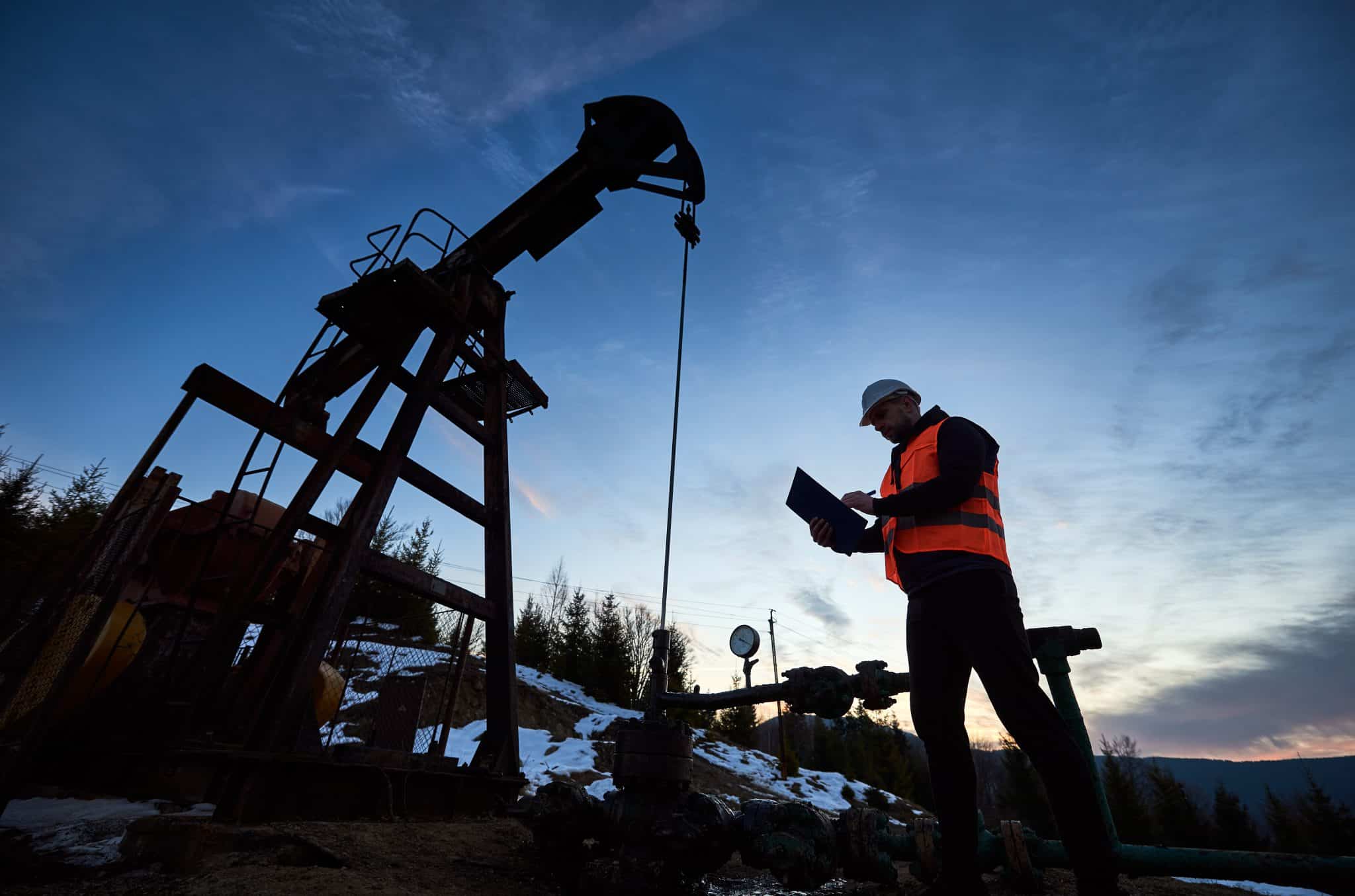 Worker reviewing a Pumpjack
